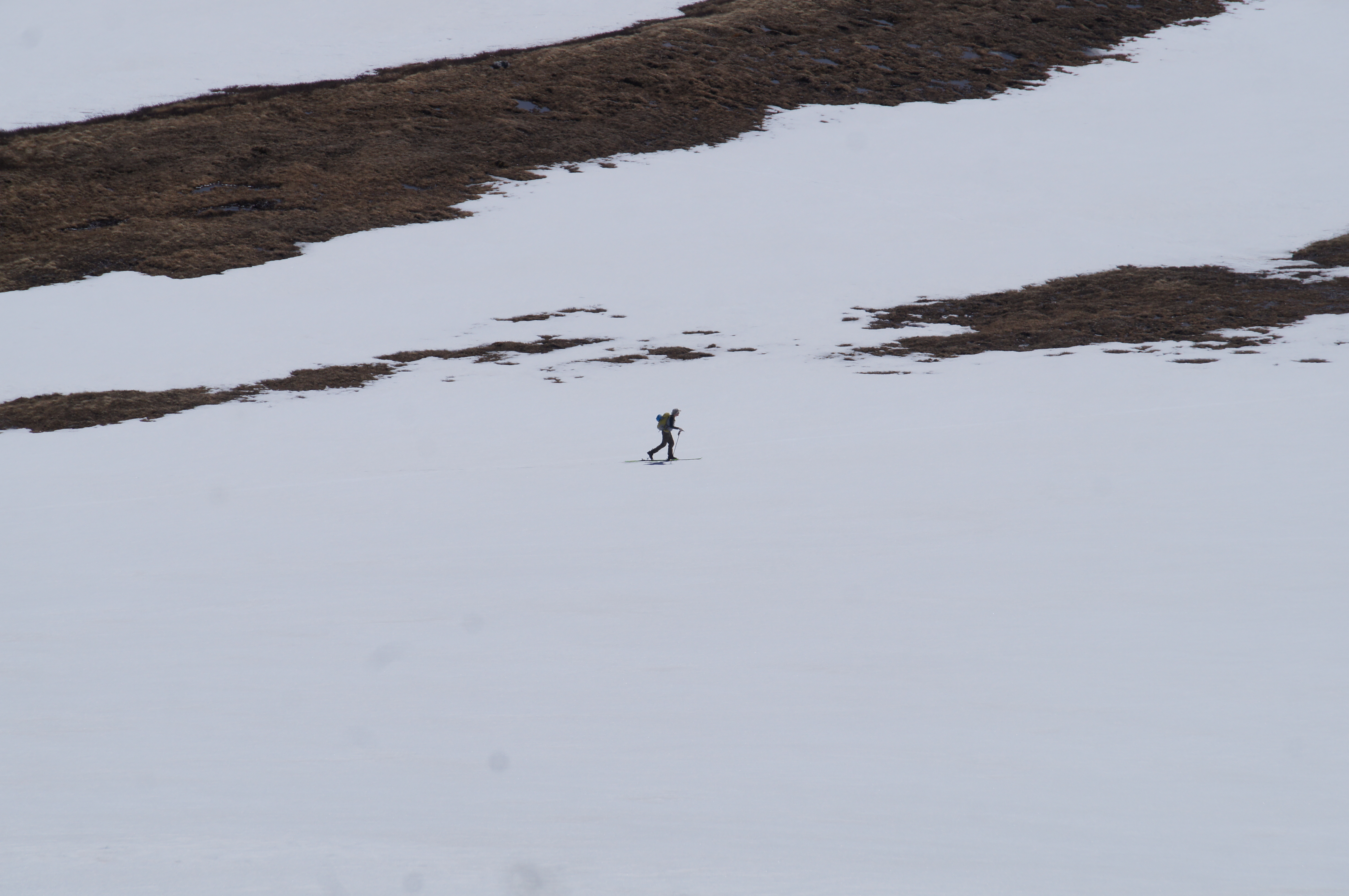 man-hiking-up-snowfield